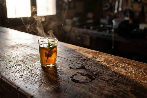 A single glass of mint tea on a worn wooden counter at dawn, no money in sight — trust as the only currency